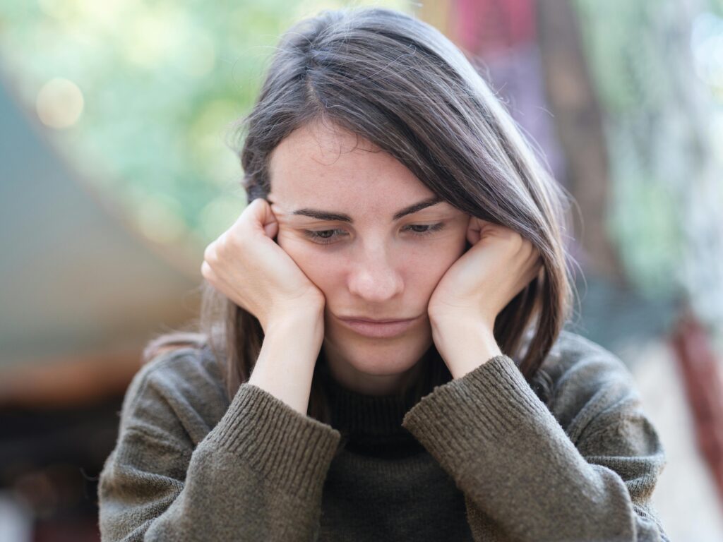 Woman feeling overwhelmed and recognizing signs that she may be pressured into an abortion decision.