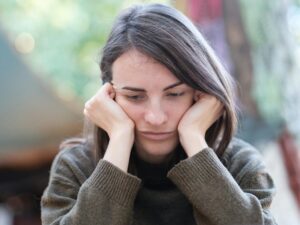 Woman feeling overwhelmed and recognizing signs that she may be pressured into an abortion decision.