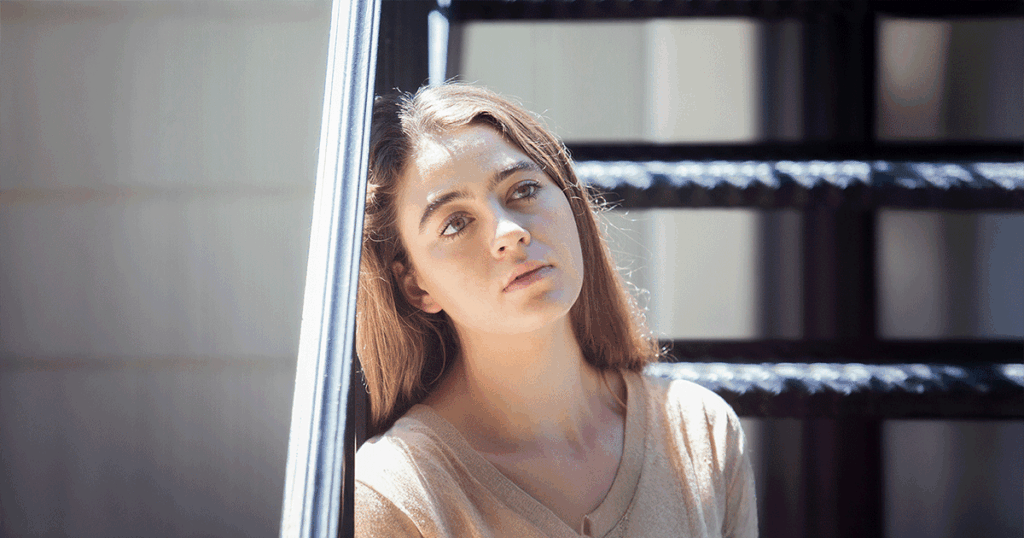 Woman feeling overwhelmed by pressure from friends and family about her pregnancy decision.